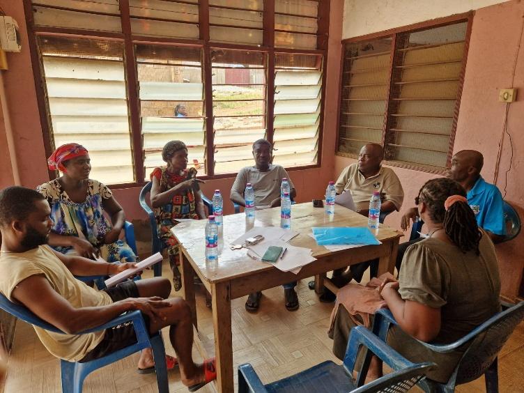 Team members in a stakeholder discussion around a table