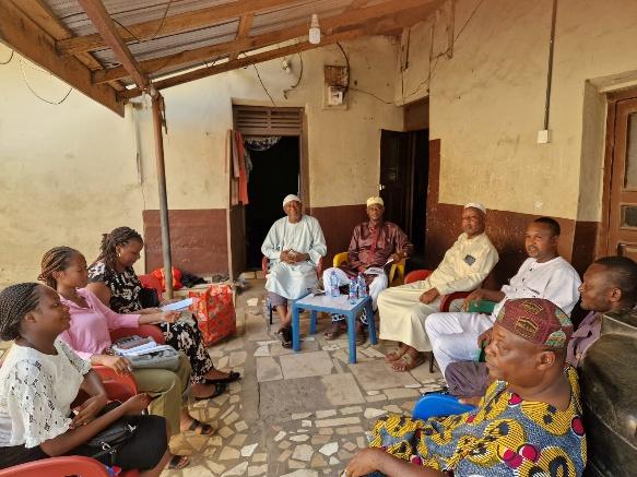 Community members gathered for a discussion in a courtyard